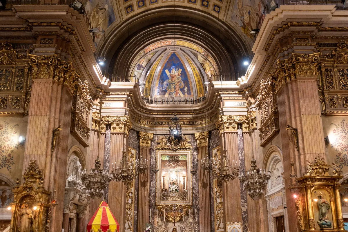 The nave of the Basílica de la Mercè seen from the entrance, with the high altar and dome ahead.